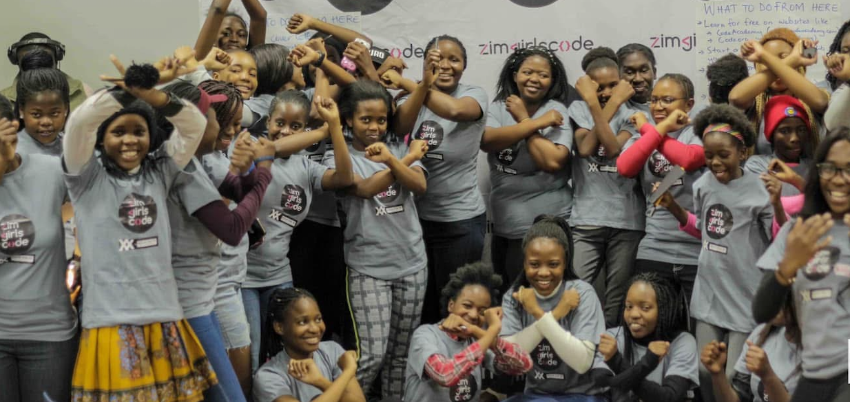 Enthusiastic group of young girls in ZimGirlsCode t-shirts celebrating together